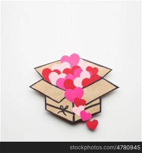 Creative valentines concept photo of a box full of hearts on white background.