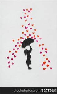 Creative valentines concept photo of a girl with umbrella and rain hearts on white background.