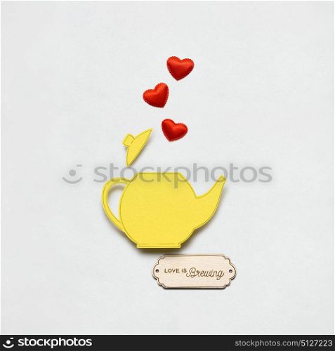 Creative valentines concept photo of a teapot made of paper on white background.