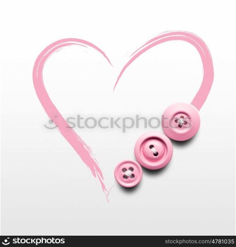 Creative valentines concept photo of buttons and illustrated heart on white background.