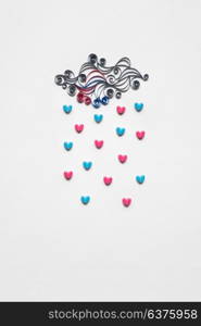 Creative valentines concept photo of cloud with hearts raining down on white background.