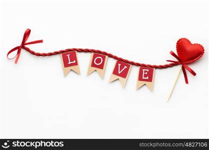 Creative valentines concept photo of flags with love sign and heart on the rope on white background.