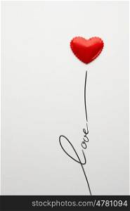 Creative valentines concept photo of heart with love sign on grey background.