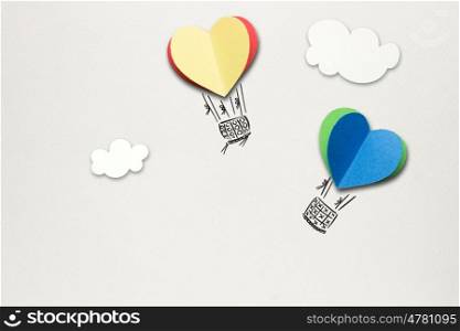 Creative valentines concept photo of hearts as aerostats on grey background.