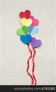 Creative valentines concept photo of hearts as balloons on grey background.