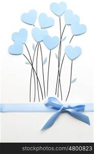 Creative valentines concept photo of hearts as flowers made of paper on white background.