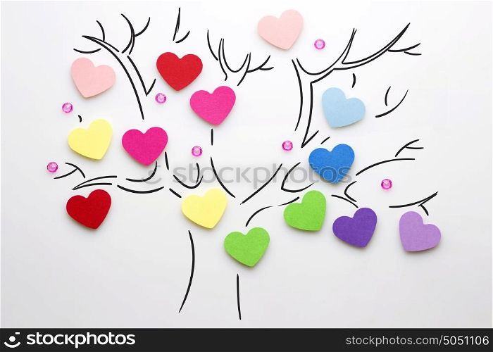 Creative valentines concept photo of hearts on the tree on white background.