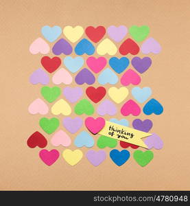 Creative valentines concept photo of hearts with the sign on brown background.