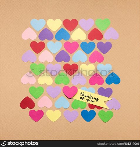 Creative valentines concept photo of hearts with the sign on brown background.