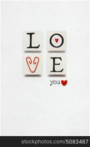 Creative valentines concept photo of love sign with a clip on white background.