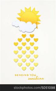 Creative valentines concept photo of sun with clouds and hearts made of paper on grey background.