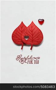 Creative valentines concept photo of two leaves with heart on white background.