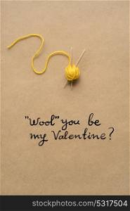 Creative valentines concept photo of woolen rope on brown background.