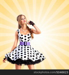 Creative vintage photo of a smiling pin-up girl wearing a retro polka-dot dress on colorful abstract cartoon style background.