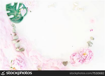 Creative wedding frame composition mock up, pink blanket, flowers, eucalyptus branches, copy space on white background. Flat lay, top view stylish art concept.. Creative wedding composition