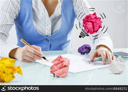 Creative woman at work. Close view of businesswoman sitting at desk in search of good idea