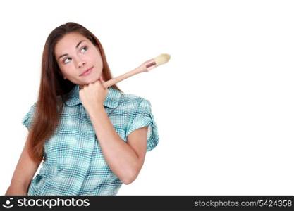 Creative woman holding an artist&rsquo;s paintbrush