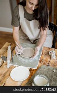 creative woman making clay pot her workshop 4