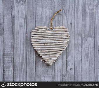 Creative wooden heart valentine on wood plank background