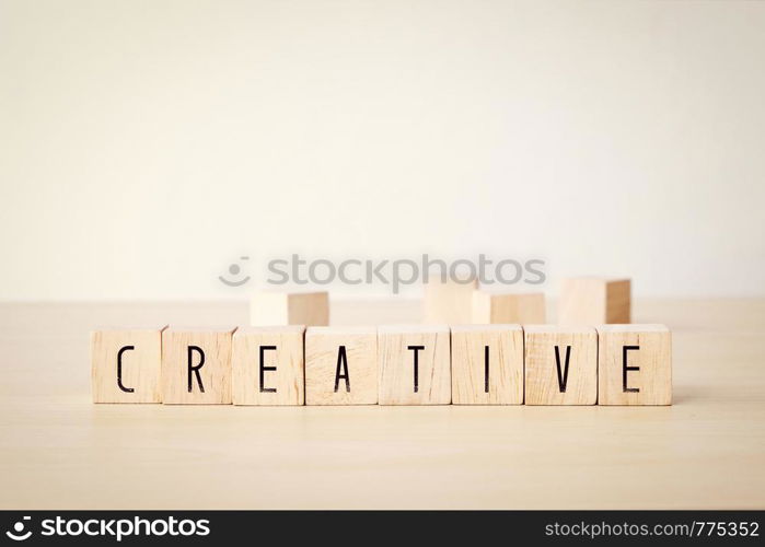 Creative word on wooden cubes background, success in business concept
