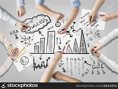 Creative work of business team. Top view of people hands drawing business teamwork strategy