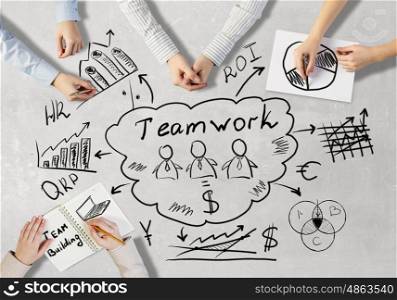 Creative work of business team. Top view of people hands drawing business teamwork strategy