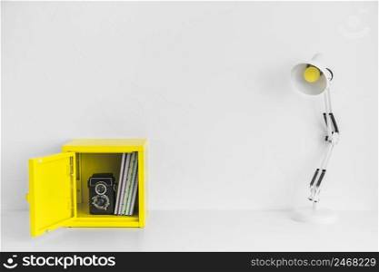 creative workplace white yellow colors with box old camera