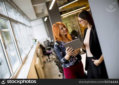 Creative young female executives using digital tablet in office