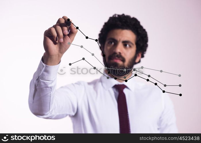 creative young middle eastern business man draw graph and diagrams with marker on virtual screen