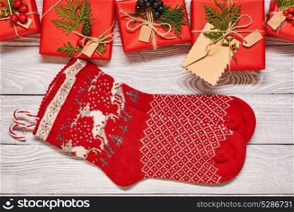 Creatively wrapped and decorated christmas presents in boxes and stockings on white wooden background.Top view from above. Copy space.
