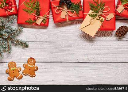Creatively wrapped and decorated christmas presents in boxes on white wooden background.Top view from above. Copy space.