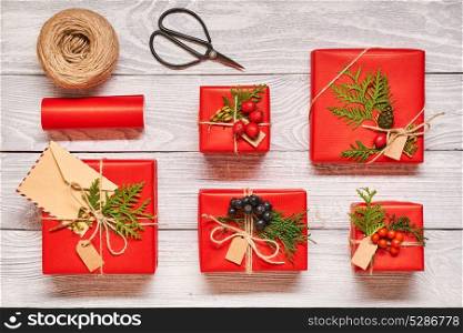Creatively wrapped and decorated christmas presents in boxes on white wooden background.Top view from above. Flat lay.