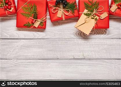 Creatively wrapped and decorated christmas presents in boxes on white wooden background.Top view from above. Copy space.