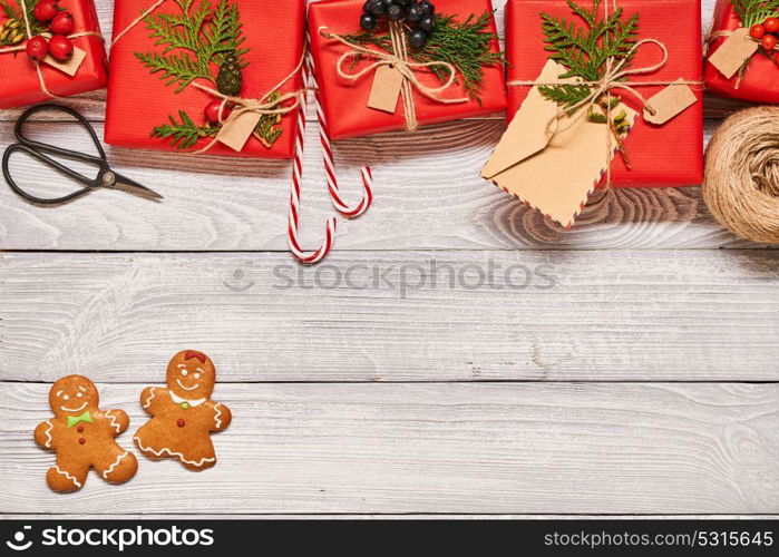 Creatively wrapped and decorated christmas presents in boxes on white wooden background.Top view from above. Copy space.