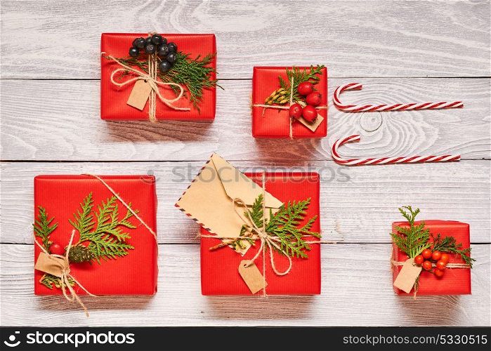 Creatively wrapped and decorated christmas presents in boxes on white wooden background.Top view from above. Flat lay.
