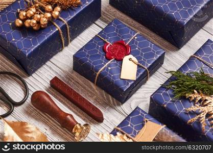 Creatively wrapped and decorated christmas presents in boxes on white wooden background. Flat lay.