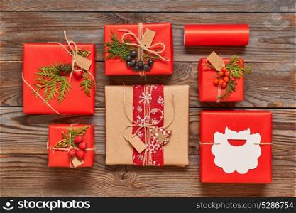 Creatively wrapped and decorated christmas presents in boxes on wooden background.Top view from above. Flat lay.