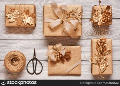 Creatively wrapped and decorated christmas presents in boxes on wooden background.Top view from above. Flat lay.