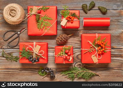 Creatively wrapped and decorated christmas presents in boxes on wooden background.Top view from above. Flat lay.