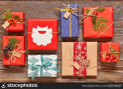 Creatively wrapped and decorated christmas presents in boxes on wooden background.Top view from above. Flat lay.