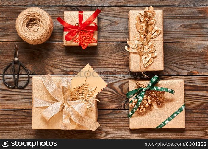 Creatively wrapped and decorated christmas presents in boxes on wooden background.Top view from above. Flat lay.
