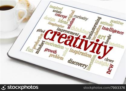 creativity concept - a word cloud on a digital tablet with a cup of coffee