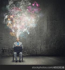 Creativity concept. Thoughtful businessman with colorful fumes above head