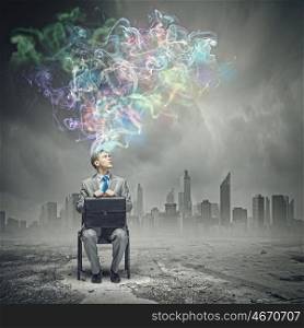 Creativity concept. Thoughtful businessman with colorful fumes above head