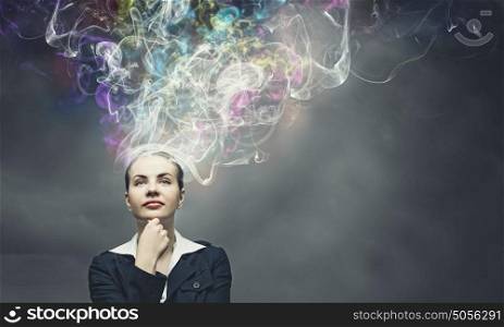 Creativity concept. Thoughtful businesswoman with colorful fumes above head