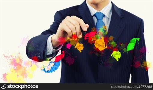 Creativity in business. Businessman against white background drawing colorful splashes with marker