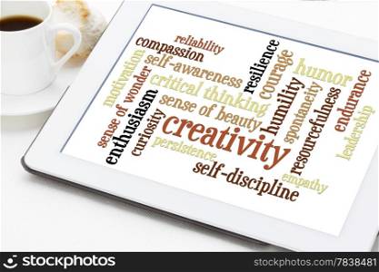 creativity, self-discipline and other personal qualities - a word cloud on a digital tablet with cup of coffee