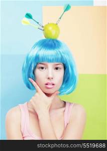 Creativity. Woman with Painted Blue Hairs and Apple on her Head