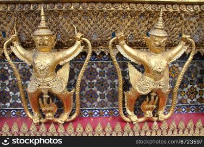 Creatutes on the wall of temple near Grand palace, Bangkok, Thailand