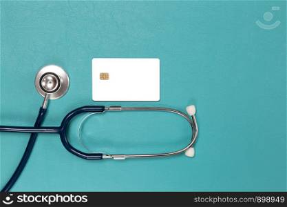 credit card and stethoscope ,concept pay for health on blue background.